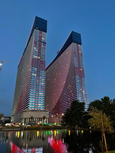 two tall buildings next to a body of water at Orbi city Panorama towers in Batumi