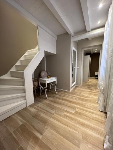 a hallway with a staircase and wooden floors at Vanessa Home in Burano