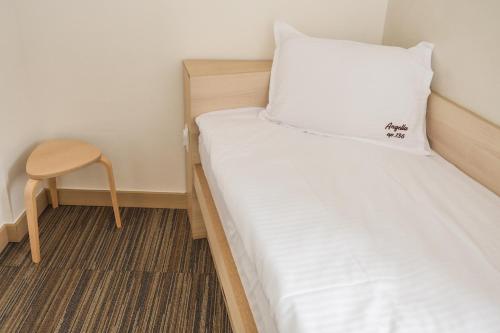a small room with a bed and a chair at Apartments Pavle in Kopaonik