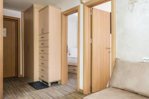 a bedroom with a closet and a bed and a drawer at Apartments Pavle in Kopaonik