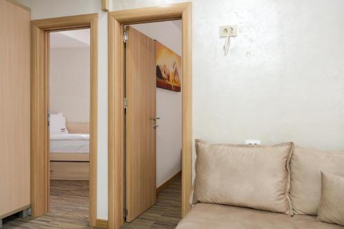 a room with a door open to a bedroom at Apartments Pavle in Kopaonik