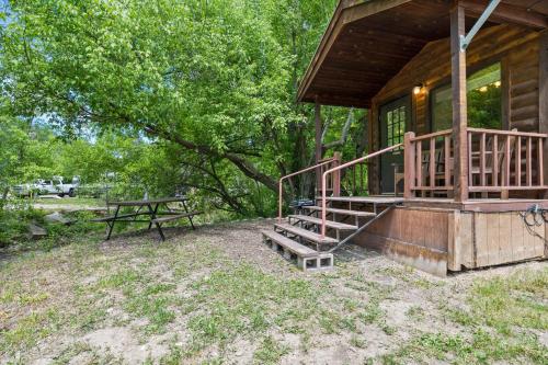 a cabin with a picnic table and stairs to the porch at HTR Durango in Durango