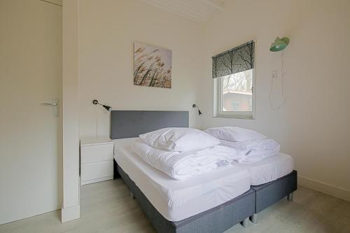 Ένα ή περισσότερα κρεβάτια σε δωμάτιο στο Vakantiehuis Zilt - Julianadorp aan Zee