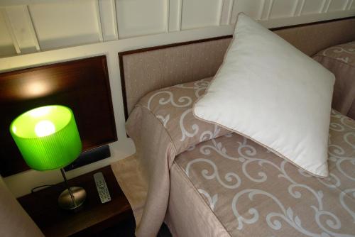 a bedroom with a bed with a pillow and a lamp at Hotel La Fonda Moreno in Morella