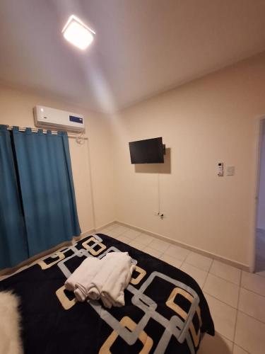 a bedroom with a bed with a black and white blanket at Departamento 1ero de Mayo (Santa Fe) in Santa Fe
