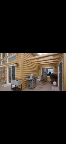 a living room with a table and a grill at Luxury Lakehouse on Oneida Lake in Blossvale