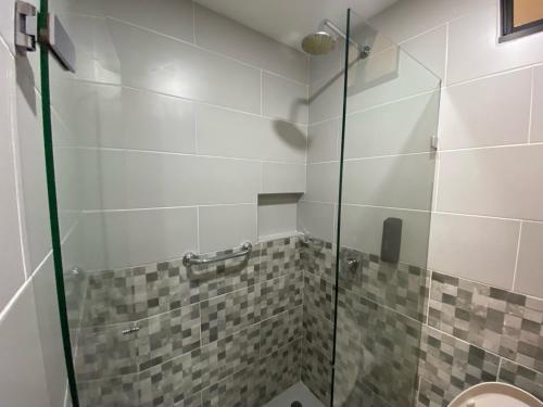 a bathroom with a glass shower with a toilet at Maidy Luxury Hotel in Medellín