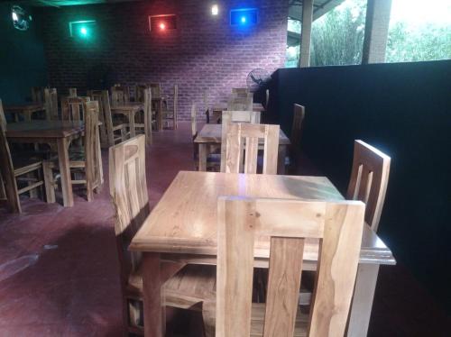 a dining room with wooden tables and chairs at Senanayaka Holiday Inn in Polonnaruwa