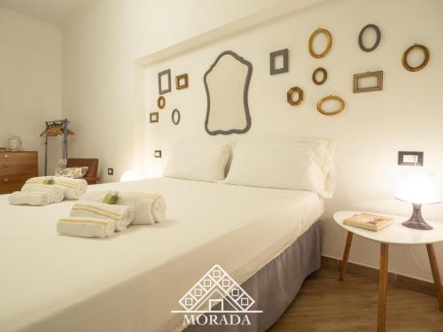a white bed with two pillows on it in a bedroom at Casa Anacleto in Iglesias