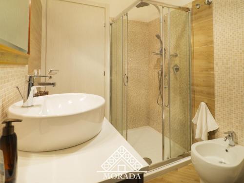 a bathroom with a tub and a sink and a shower at Casa Anacleto in Iglesias