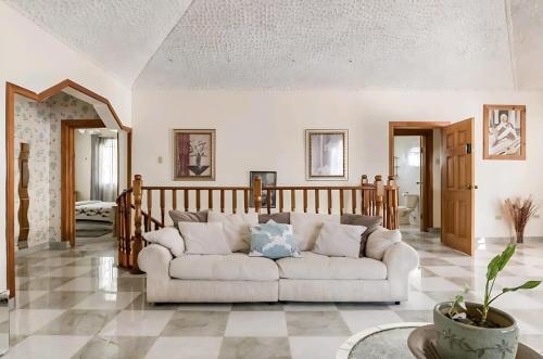 a living room with a couch in the middle at Joyful Ambiance Retreat in Bushy Park