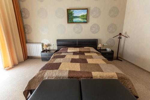 a bedroom with a bed with a checkeredkered at Аполлонія in Poltava