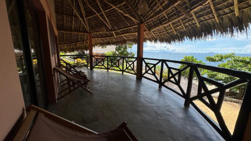 a balcony of a house with a view of the ocean at VERONIKA Resort Nosy Komba in Nosy Komba