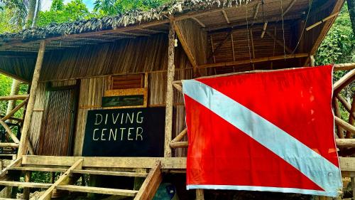 a flag is hanging in front of a building at VERONIKA Resort Nosy Komba in Nosy Komba