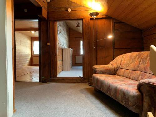 a living room with a couch and a large mirror at Revier lauschig und charmant in Dornhaus