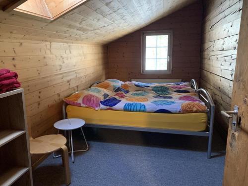 a bedroom with a bed in a wooden cabin at Revier musisch und historisch in Diesbach