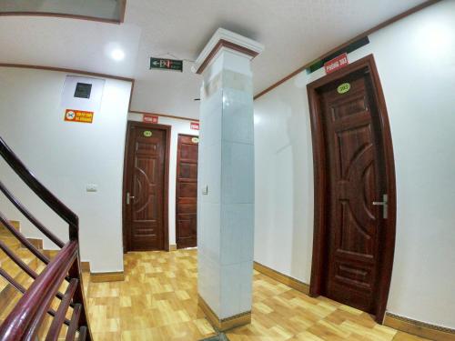 a row of elevators in a building with wooden doors at Minh Hưng Hostel in Sa Pa