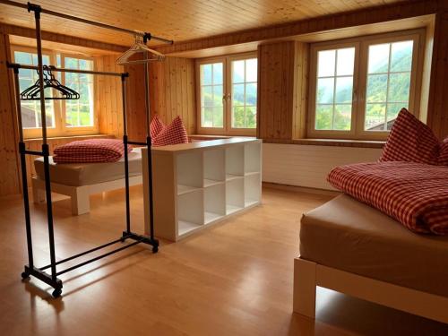 a room with a room with two beds and windows at Revier Bliili und Spitzer in Diesbach