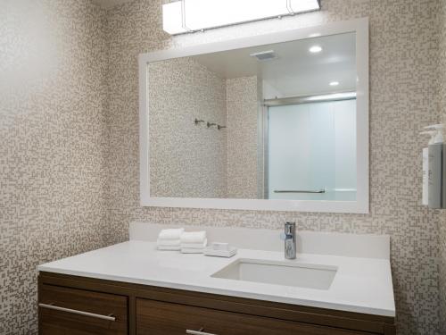 a bathroom with a sink and a mirror at Home2 Suites By Hilton Atlanta Airport College Park in Atlanta