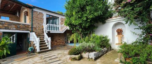 a house with a stairway leading to a building at A Quinta da Colina Adega in Castanheira de Pêra
