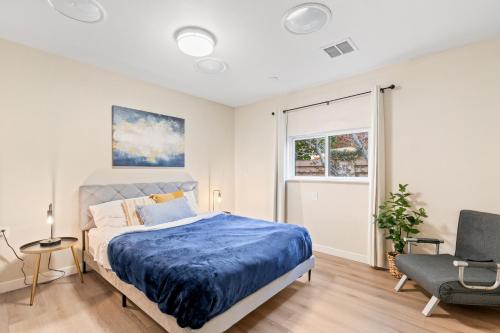 a bedroom with a bed and a chair and a window at 1 Bedroom Apt near Santana Row, recently remodeled in San Jose