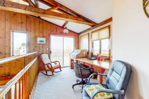 a home office with a desk and chairs and windows at Audrey Leigh in Newburyport