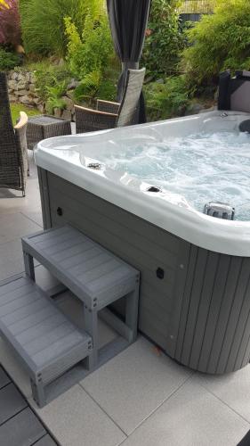 a jacuzzi tub with a bench on a patio at Ferienhaus Fee in Erbach