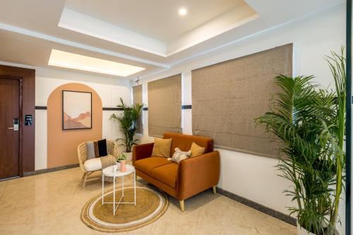 a waiting room with a couch and a table at Olive Hebbal - by Embassy Group in Bangalore