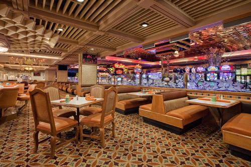 a restaurant with tables and chairs and a bar at Maverick Hotel and Casino by Red Lion Hotels in Elko