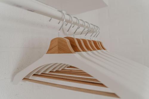 a closet with a rack of wooden clothes at Design Holiday Home in Ermelo