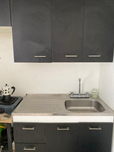 a kitchen with a sink and a stove at Close in Manizales