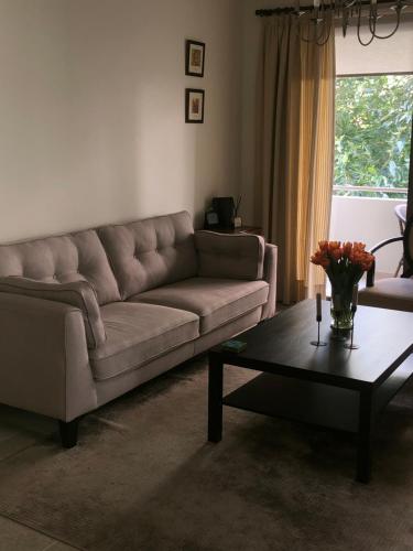 a living room with a couch and a coffee table at T&L Apartments Germasogia in Limassol