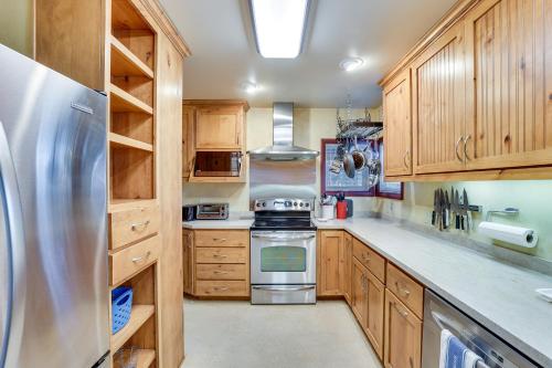 a kitchen with wooden cabinets and a stainless steel refrigerator at Pet-Friendly Boise Getaway 2 Mi to Downtown! in Boise