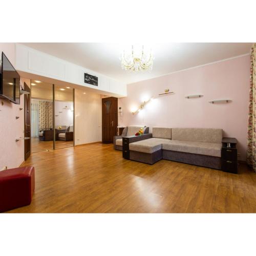 a large living room with a couch and a table at Naykova district Apartments in Kharkiv