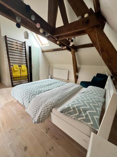 a bedroom with two beds in a attic at Maison de Haouret in Libaros