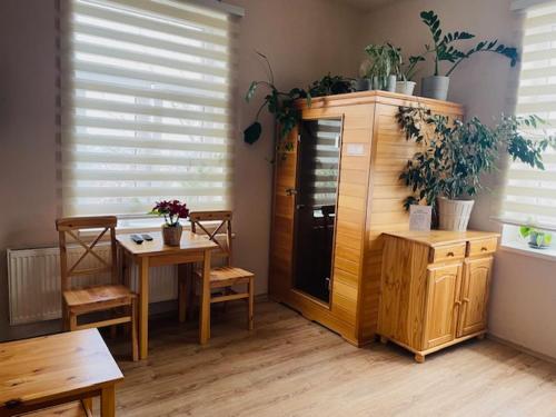 a room with a table and a dining room with plants at Apartmán Lucián in Prague