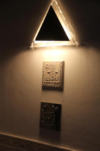 a light on a wall with a plate on it at La Porta sui Monti di Luna in Carrara
