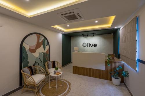 an office lobby with a give counter and chairs at Olive Hebbal - by Embassy Group in Bangalore