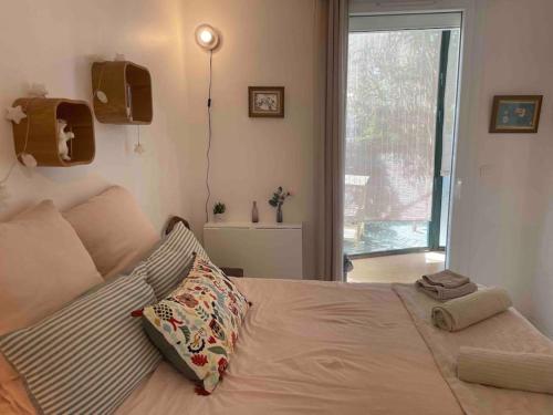 a bedroom with a bed with a pillow and a window at Charming Studio to Venelles 10 minutes from Aix in Venelles