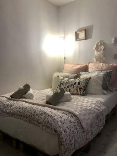 a bedroom with a large bed with pillows on it at Charming Studio to Venelles 10 minutes from Aix in Venelles