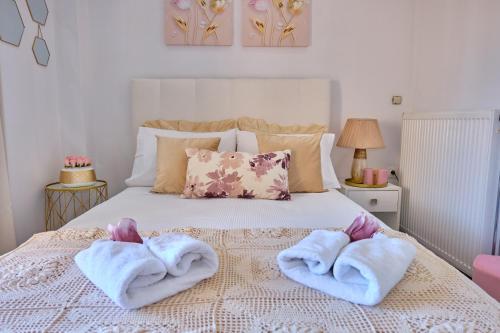 a bedroom with a bed with towels on it at Elena Luxury Suite Agios Stefanos in Agios Stefanos