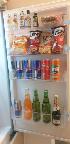 an open refrigerator filled with lots of drinks and snacks at R-RESIDENCY DELUXE in Banja Luka