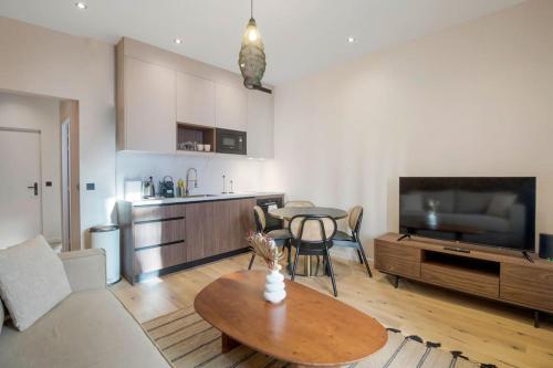 un salon avec une table et une cuisine avec une télévision dans l'établissement 11.Appart 4Pers#1 Bedroom #Père Lachaise #Nation, à Paris