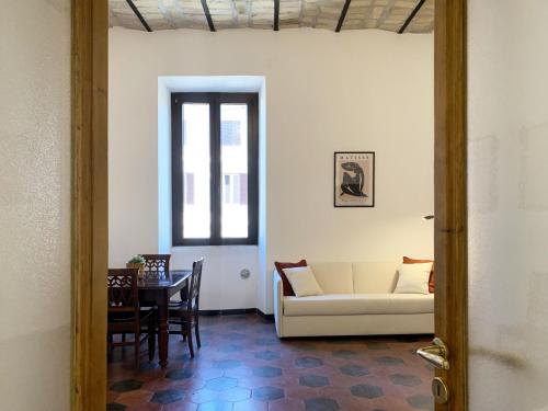a living room with a white couch and a table at RomeAsYouLike - Vatican Apartment N°73 in Rome