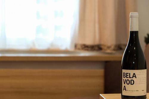 a bottle of red wine sitting on a table at Apartments Pavle in Kopaonik