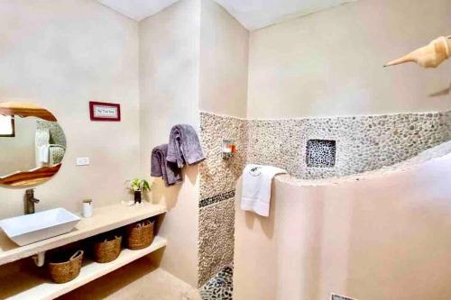 a bathroom with a sink and a shower at Casa Libelula Beachfront House in Holbox Island