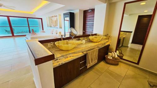 a bathroom with two sinks and a counter with bowls at Villa Azul Maya in Isla Mujeres