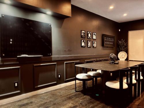 a dining room with a table and a flat screen tv at Trio Sonata, 3-Bed Rock n Roll Residence in Northern Liberties in Philadelphia