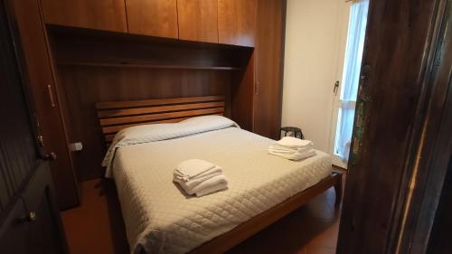 a bedroom with a bed with two towels on it at Casa Martino in Castel di Sangro