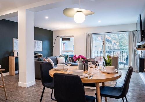 a dining room and living room with a table and chairs at Powder Village Retreat by Revelstoke Vacations in Revelstoke